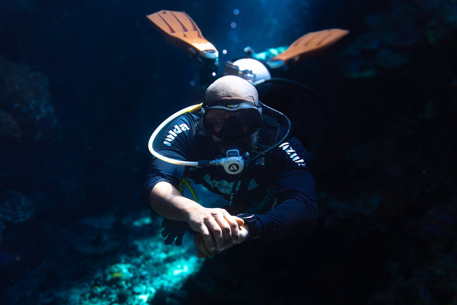Jalvan diving in the deep blue waters of Marsa Alam, Egypt, checking his dive computer during a Red Sea expedition.